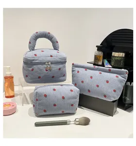 Light blue corduroy cosmetic bag set with strawberry print in three different sizes