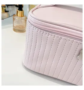 Close-up detail of a pink quilted PU leather makeup bag showing fine stitching and texture