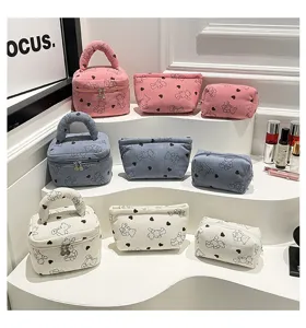 Collection of corduroy makeup bags with cute bear print in pink, blue, and white colors