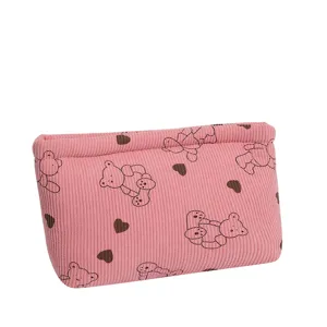 Detailed view of a pink corduroy makeup bag with cute bear and heart prints