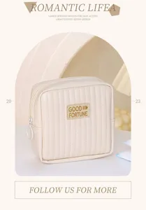 Detail view of the cream-colored quilted cosmetic pouch featuring a retro square design