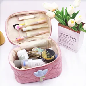 Close-up detail of a large capacity pink corduroy makeup bag featuring a cute tulip decoration