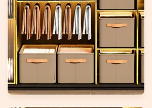 Foldable fabric storage boxes organizing clothes in a luxury gold frame wardrobe