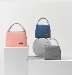 Detail showing three colors of Oxford insulated bags on stylish display pedestals