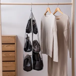 Detail of a 6-pocket hanging handbag organizer used in a clean minimalist closet setup.