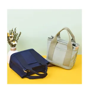 Detailed view of two Japanese style canvas tote bags in navy blue and sage green.
