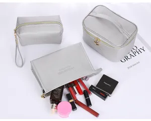 Detailed display of silver cross-pattern PU makeup bags with organized cosmetics