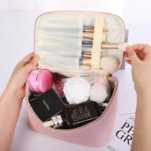 Large capacity pink cross-pattern PU leather cosmetic bag and portable makeup organizer.