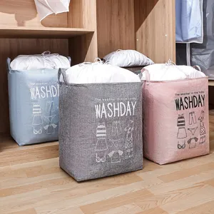 Set of 3 large fabric laundry storage bags with drawstring closure in a wood closet