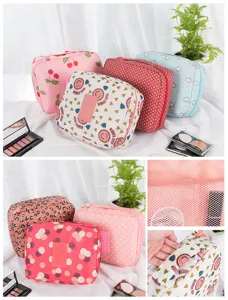 Close-up of patterned travel cosmetic bags showing internal mesh pockets and top handles