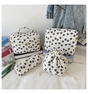Detailed view of 4-piece quilted floral storage set including pouch and drawstring bag