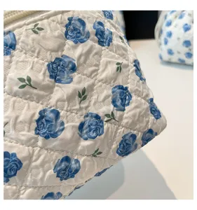 Detail of quilted cotton fabric with blue rose floral pattern for cosmetic bag