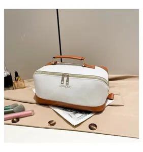 Detailansicht einer weißen PU-Kosmetiktasche mit Palmenmuster, braunen Akzenten und Goldlogo.