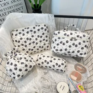 Set of four floral quilted cosmetic bags displayed with makeup items in a wire shopping cart