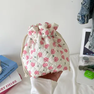 Close-up of a floral quilted cotton drawstring pouch for convenient cosmetic storage