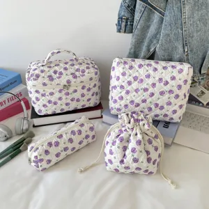 4-piece quilted floral makeup bag set with purple flower pattern in lifestyle setting