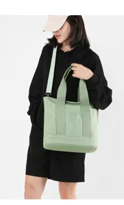 Stylish mint green canvas tote bag with adjustable shoulder strap for daily commute