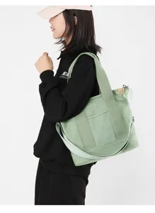 Side view of a large green Japanese canvas bag worn by a model for daily commuting
