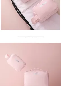 Light pink portable travel makeup bag with handle and zipper closure for storage