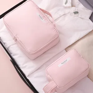 Set of two pink travel makeup organizer bags with portable handles and zip closure