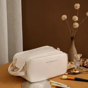 Detail of cream PU leather double-zippered makeup bag with elegant vanity setting