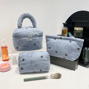 Three-piece light blue corduroy cosmetic bag set with cute bear and heart pattern prints.