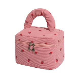Professional pink corduroy makeup bag with cute strawberry pattern and round handle