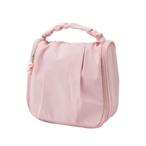 Bolsa de maquillaje rosa portátil con dijes de perlas para viaje