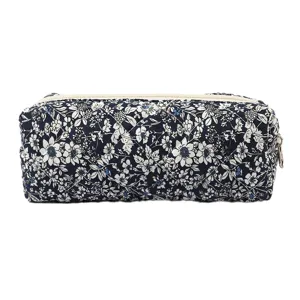 Detail shot of a navy blue floral quilted cotton makeup bag for portable storage