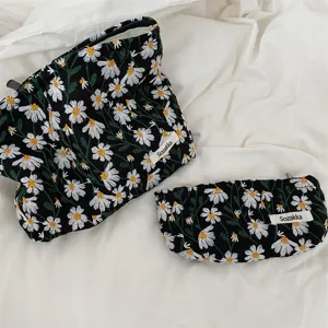 Fresh floral embroidered cosmetic bag and pencil case set with daisy pattern details.