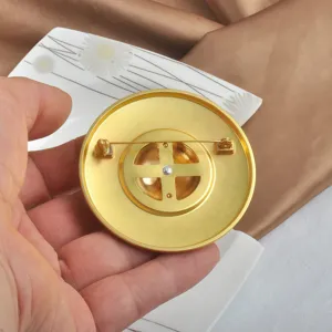 Detail showing the back fastening on a large minimalist matte gold round brooch
