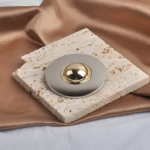 Close-up of a premium two-tone gold and silver circular brooch with mirror-like finish.