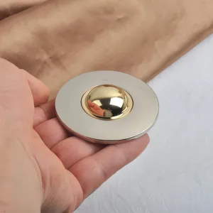 Detailed view of a two-tone gold and silver mirror finish circular brooch