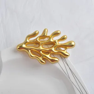 Detailed macro view showing the textured matte gold finish of a coral shaped branch brooch pin