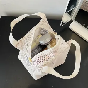 Portable cream nylon mesh cosmetic bag for toiletries and beach storage.