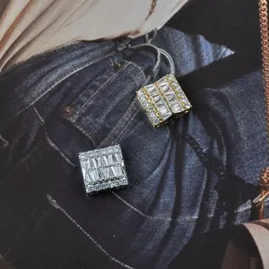 Detailed view of square magnetic brooches with sparkling clear rhinestones