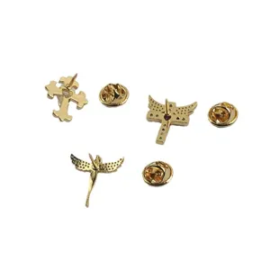 Detailed view of mini gold-plated cross and angel wings lapel pin set with clutches
