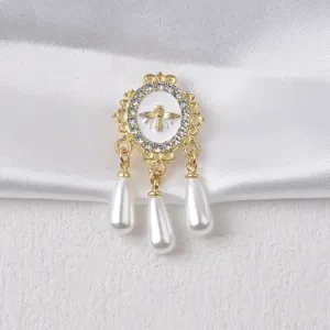 Detailansicht goldene Bienenbrosche mit Strass und drei Perlen-Tropfenanhängern