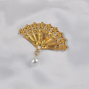 Exquisite gold-plated Chinese fan brooch with a teardrop pearl pendant on silk fabric