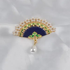 Detailed macro shot of an elegant Chinese fan brooch with blue enamel and pearls