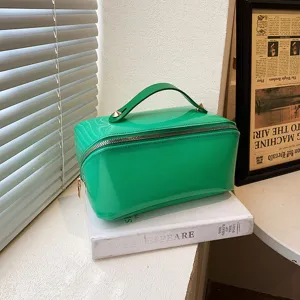 Large capacity vibrant green glossy travel makeup bag with a stylish top handle design