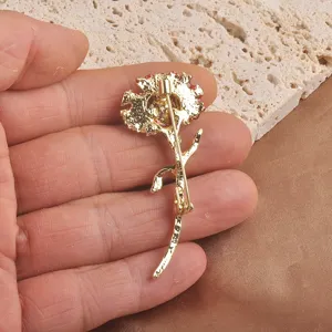 Macro view showing the back structure of a golden carnation flower brooch pin for suits