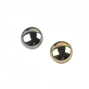 Macro view showing the glossy reflective surface of gold and silver metallic round brooches