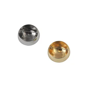 Macro view of gold and silver round metal brooches showing the back safety pin mechanism