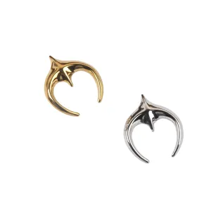 Detailed view of stylized star-moon stainless steel brooches in gold and silver finish