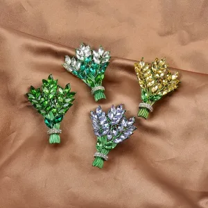 Detailansicht von vier eleganten Lavendel-Bouquet-Broschen mit bunten Kristallen auf Satin.