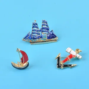 Set of nautical enamel brooches featuring blue sailing ship, red sailboat and anchor