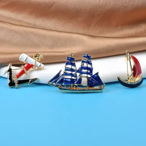 Detail view of vintage enamel maritime brooches featuring anchor and sailing ships
