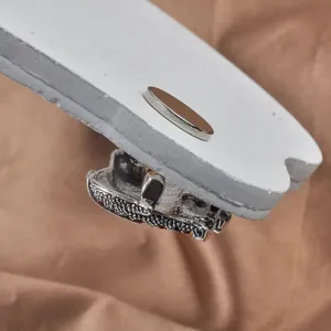 Close-up of silver magnetic brooch converter clasp shown on a white fabric simulation display.