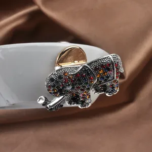 Close-up of sparkling multicolor rhinestone elephant magnetic brooch converter on silk